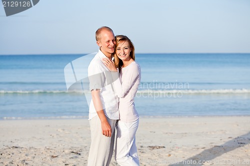 Image of happy couple in love having fun on the beach