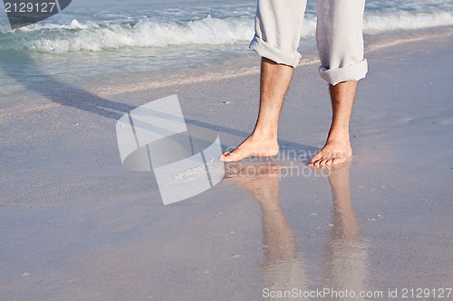 Image of barefoot in the sand in summer holidays