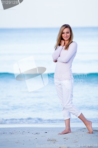 Image of attractive young blonde woman relaxing on the beach