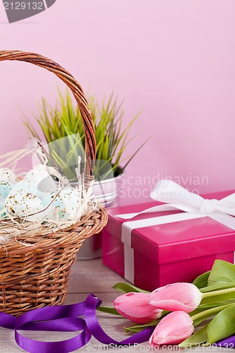 Image of pink present and colorful tulips festive easter decoration