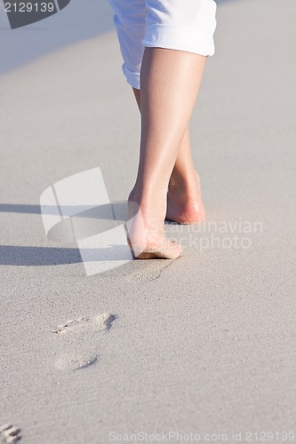 Image of barefoot in the sand in summer holidays