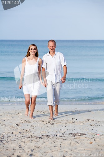 Image of happy couple in love having fun on the beach