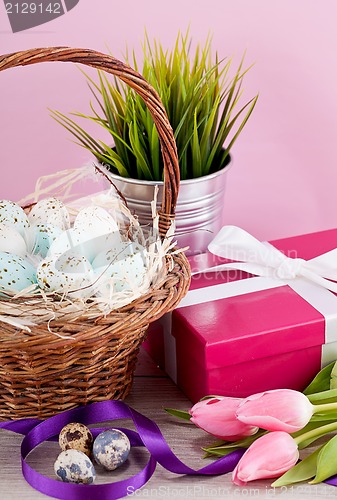 Image of pink present and colorful tulips festive easter decoration