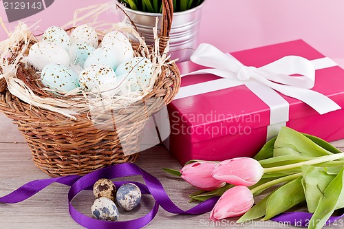 Image of pink present and colorful tulips festive easter decoration