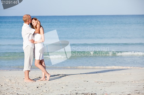Image of happy couple in love having fun on the beach