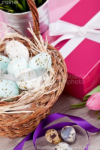 Image of pink present and colorful tulips festive easter decoration