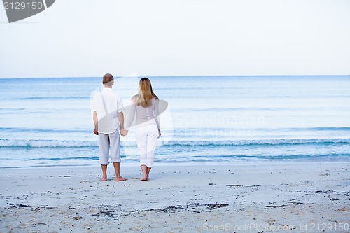 Image of happy couple in love having fun on the beach
