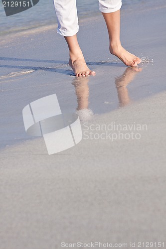 Image of barefoot in the sand in summer holidays