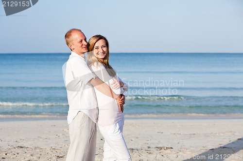 Image of happy couple in love having fun on the beach