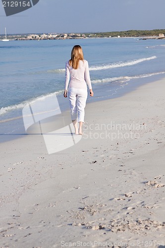 Image of attractive young blonde woman relaxing on the beach