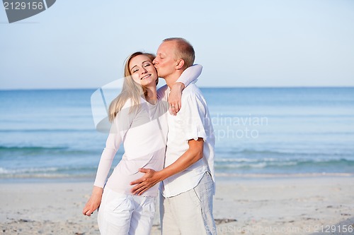 Image of happy couple in love having fun on the beach