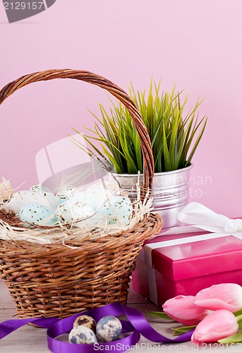 Image of pink present and colorful tulips festive easter decoration