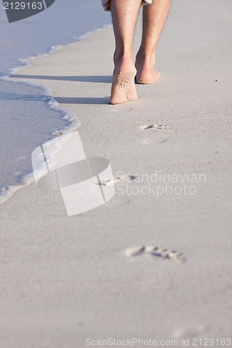 Image of barefoot in the sand in summer holidays