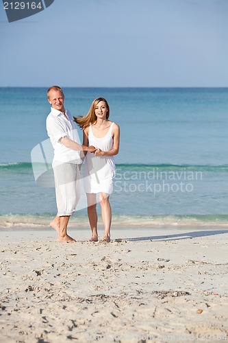 Image of happy couple in love having fun on the beach