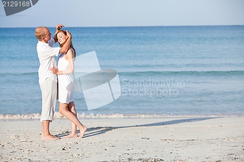 Image of happy couple in love having fun on the beach