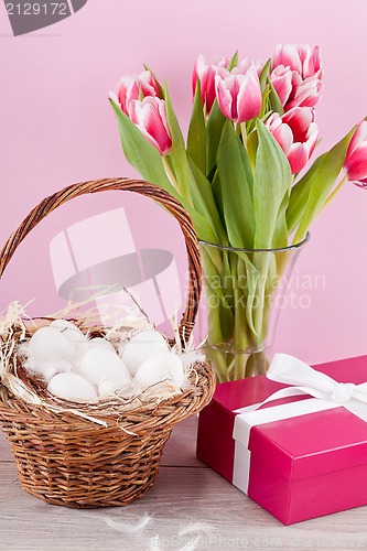 Image of pink present and colorful tulips festive easter decoration