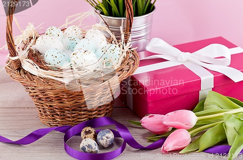 Image of pink present and colorful tulips festive easter decoration