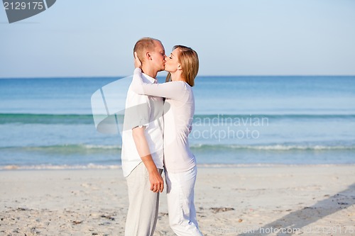 Image of happy couple in love having fun on the beach
