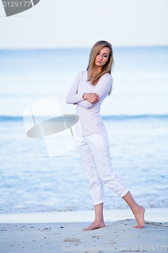 Image of attractive young blonde woman relaxing on the beach