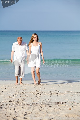 Image of happy couple in love having fun on the beach