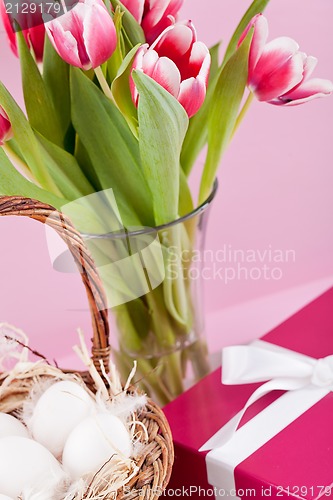 Image of pink present and colorful tulips festive easter decoration