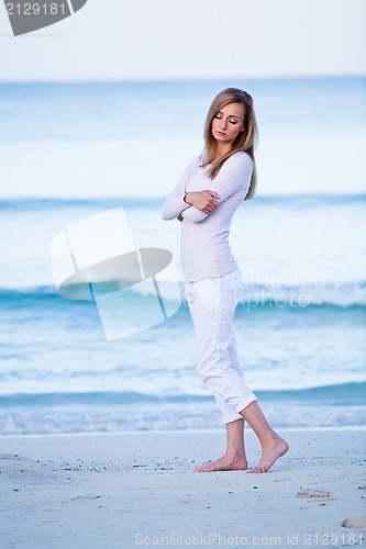 Image of attractive young blonde woman relaxing on the beach