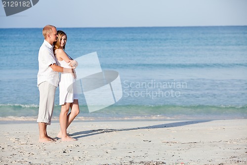 Image of happy couple in love having fun on the beach