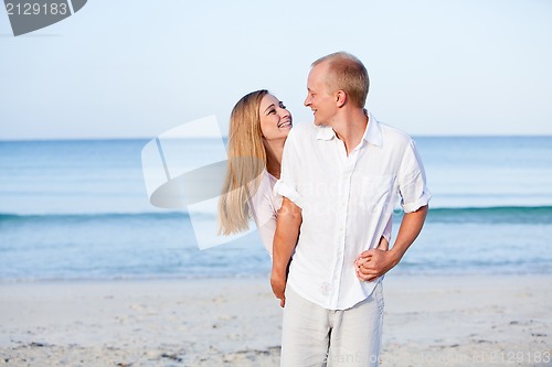 Image of happy couple in love having fun on the beach