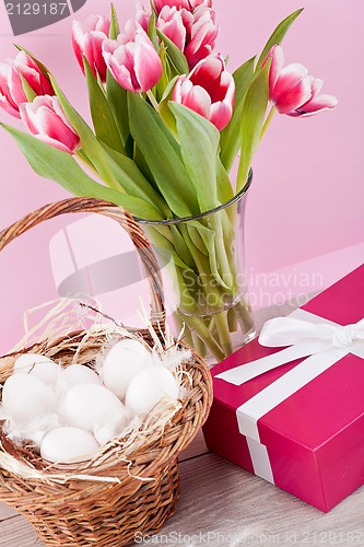 Image of pink present and colorful tulips festive easter decoration