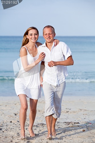 Image of happy couple in love having fun on the beach
