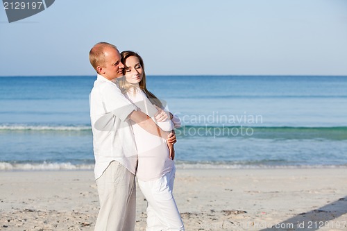 Image of happy couple in love having fun on the beach