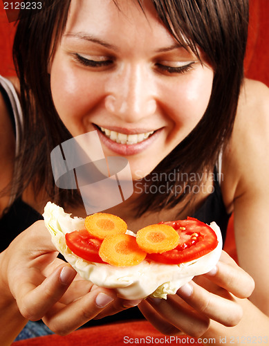 Image of Woman eating sandwich