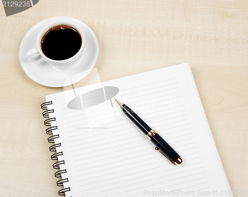 Image of White cup and white page 