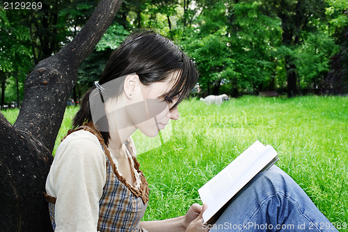 Image of Young woman reading a novel 