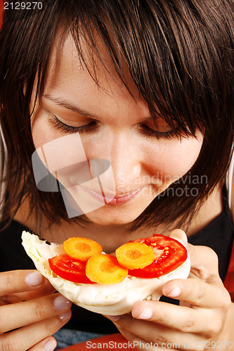 Image of Beautiful woman eating  