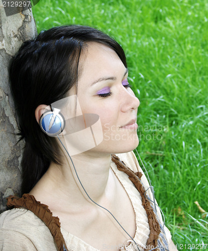 Image of Young woman listening music