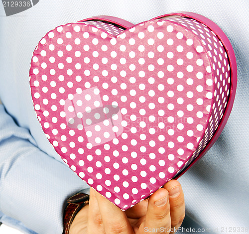 Image of Businessman hiding a gift