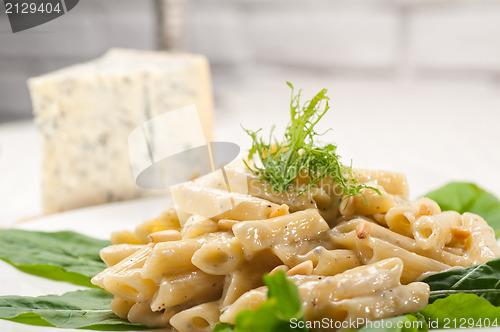 Image of Italian pasta penne gorgonzola and pine nuts