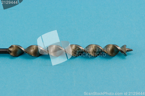 Image of special thick wood drill bit on blue background 