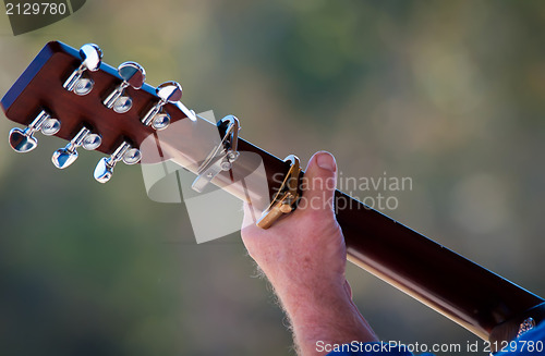 Image of man hand with guitar