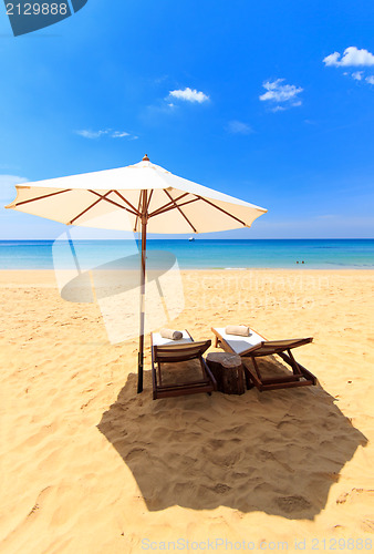 Image of beds and umbrella on a beach