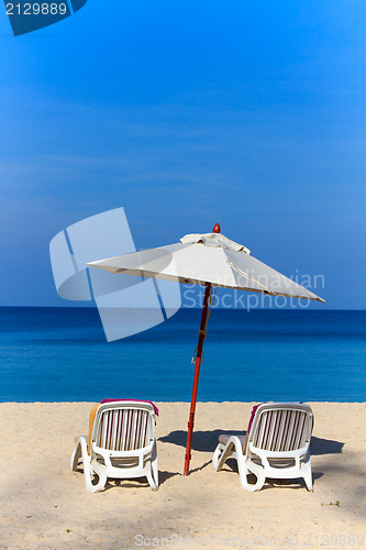 Image of beds and umbrella on a beach