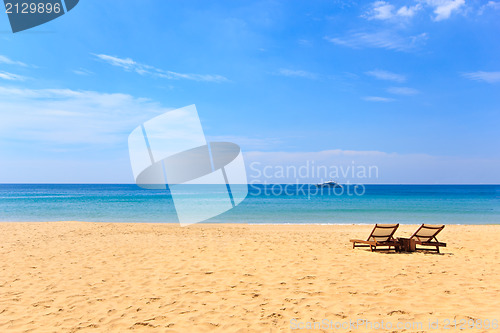 Image of beds and umbrella on a beach