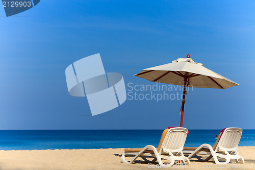 Image of beds and umbrella on a beach