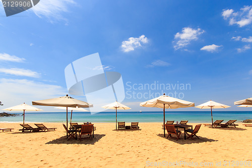 Image of beds and umbrella on a beach