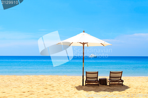 Image of beds and umbrella on a beach