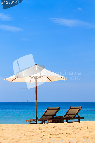 Image of beds and umbrella on a beach