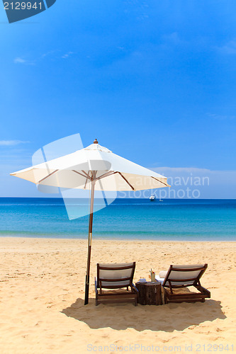Image of beds and umbrella on a beach