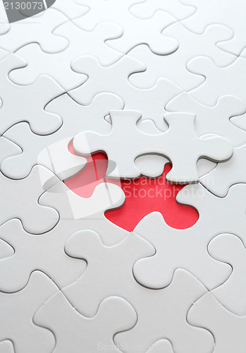 Image of puzzle with missing red piece