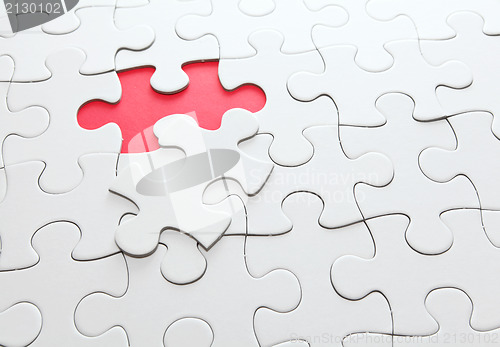 Image of puzzle with missing red piece